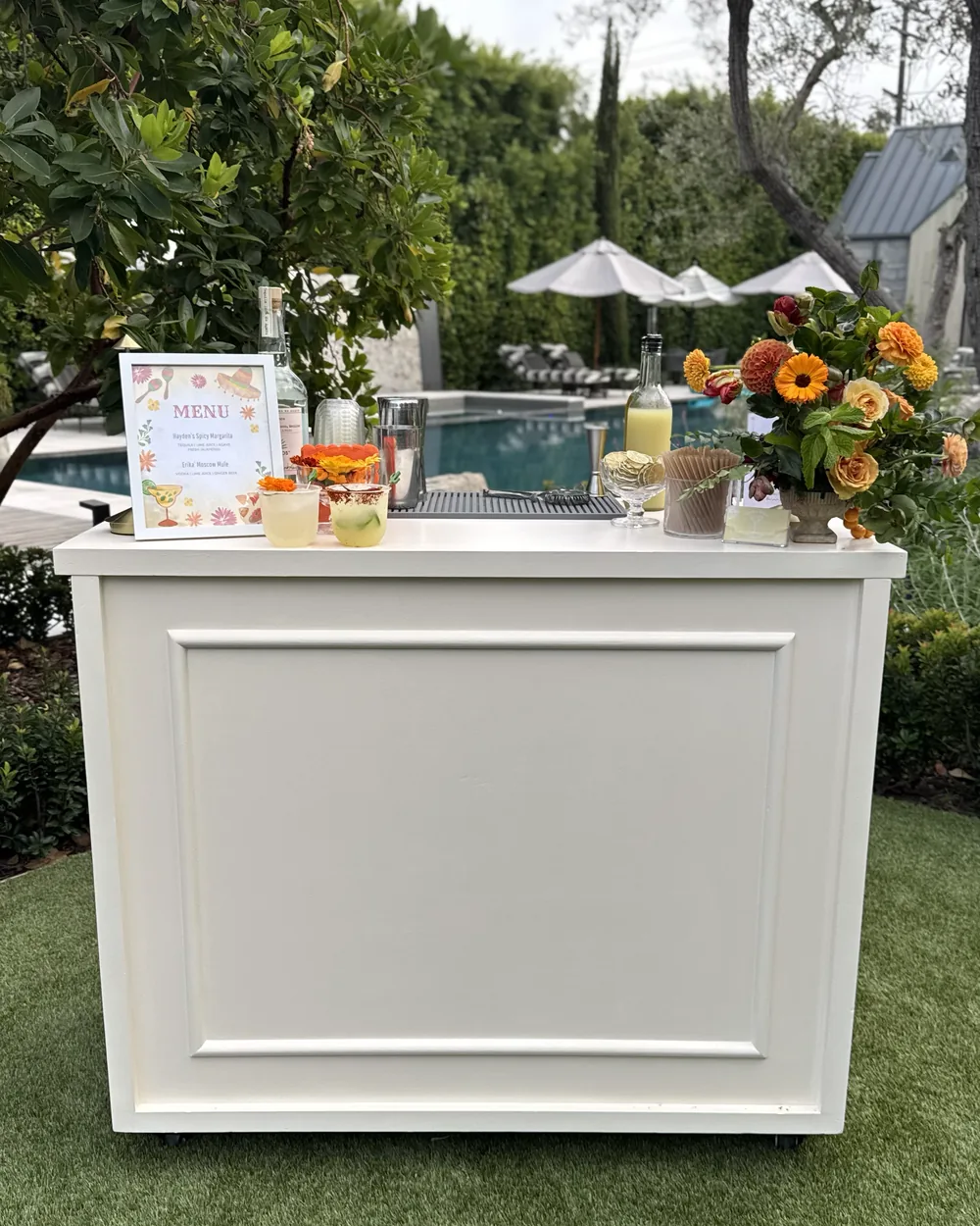 The Ivory bar, a white panelled mobile bar set up beside a pool