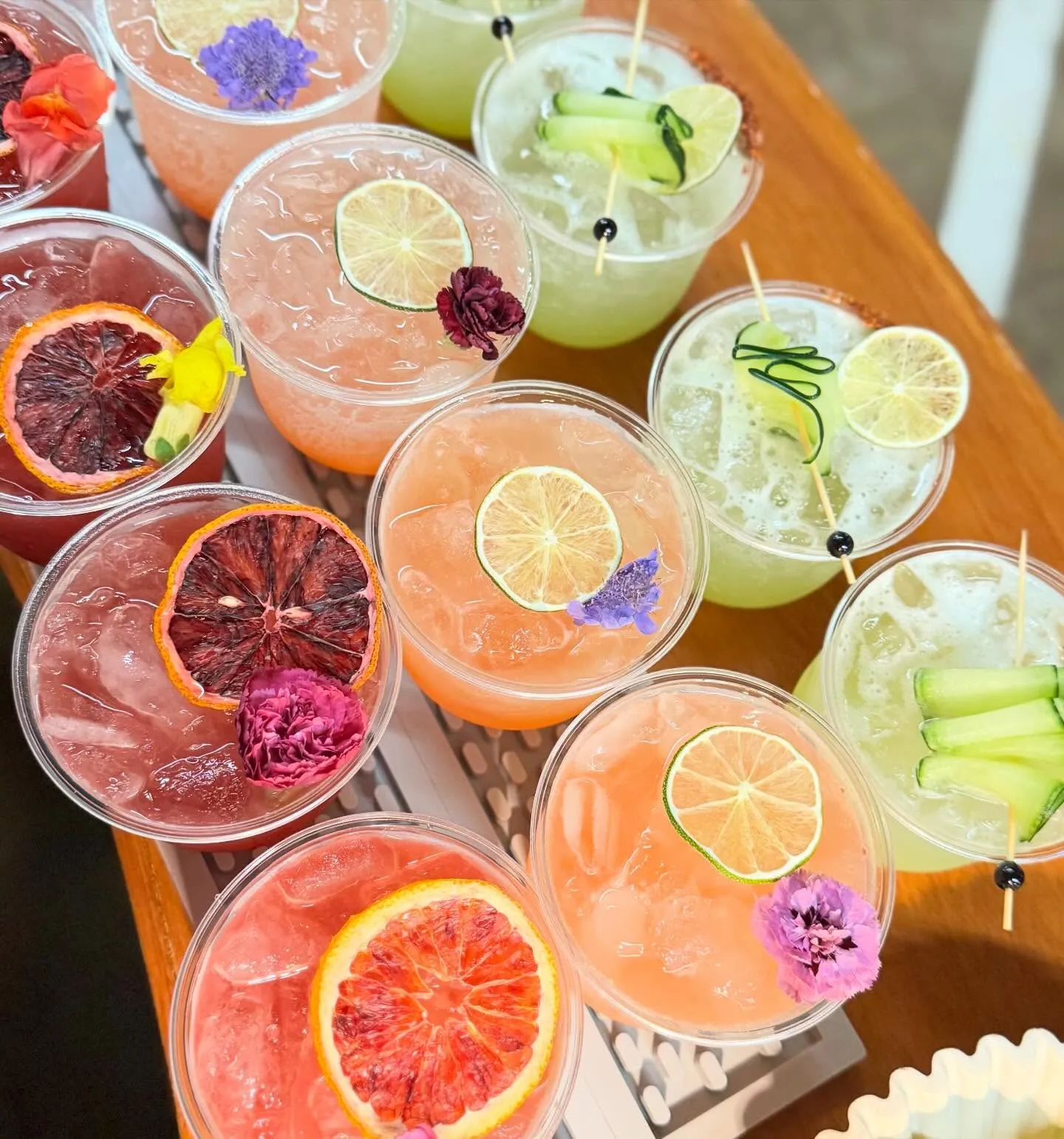Overhead view of blood orange and grapefruit cocktails with edible flowers