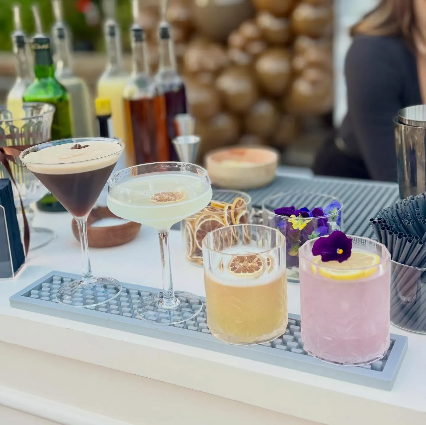 Espresso martini topped with foam and a pressed flower