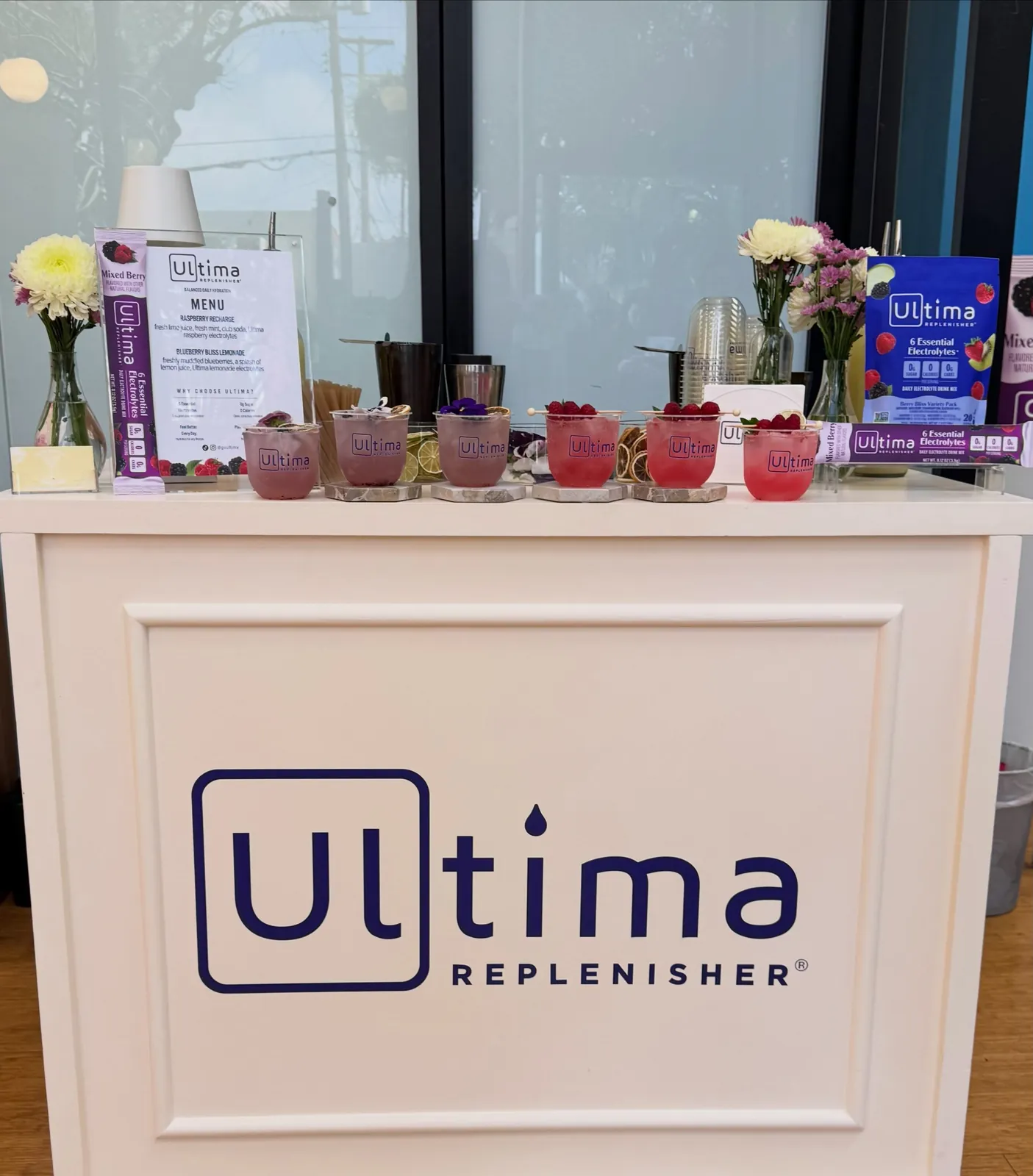 A branded bar cart set up for an Ultima Replenisher event
